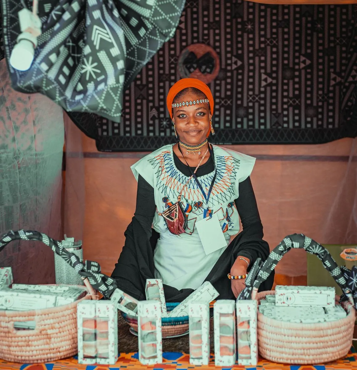 An artisan at her stall with her products