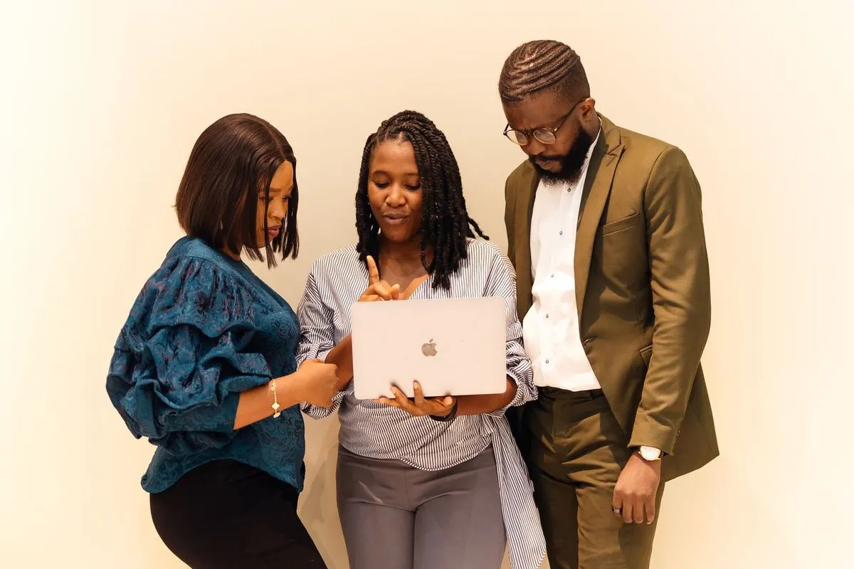 Colleagues around a laptop